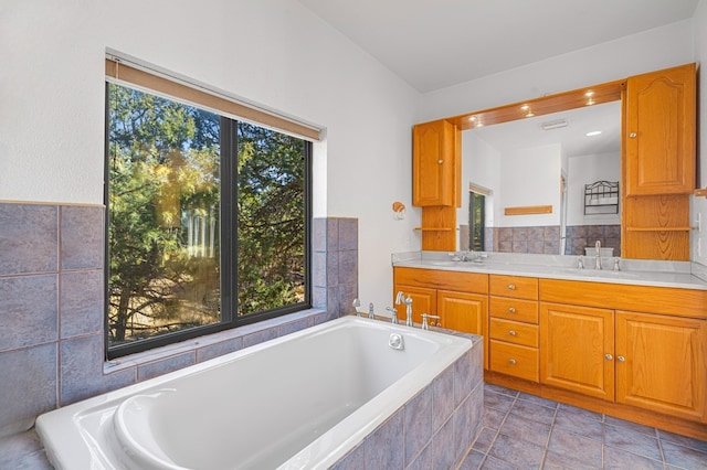 bathroom with a healthy amount of sunlight, a sink, and double vanity