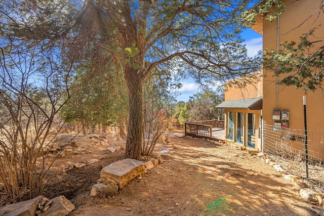 view of yard with fence and a wooden deck