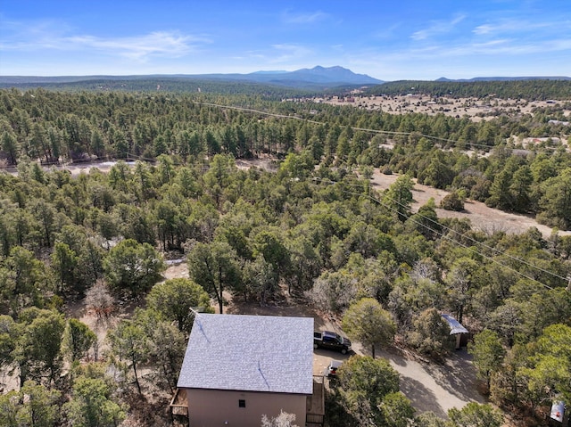 aerial view featuring a mountain view and a view of trees