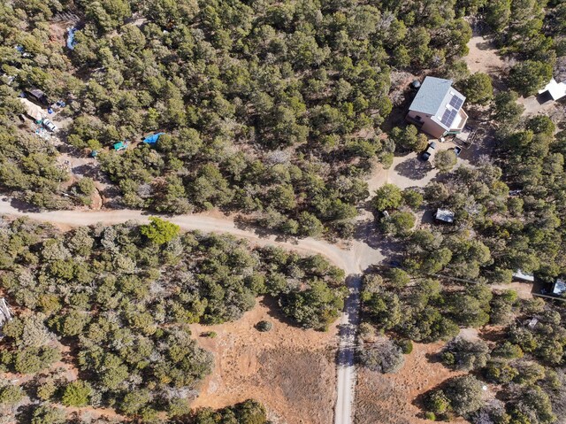 birds eye view of property with a wooded view