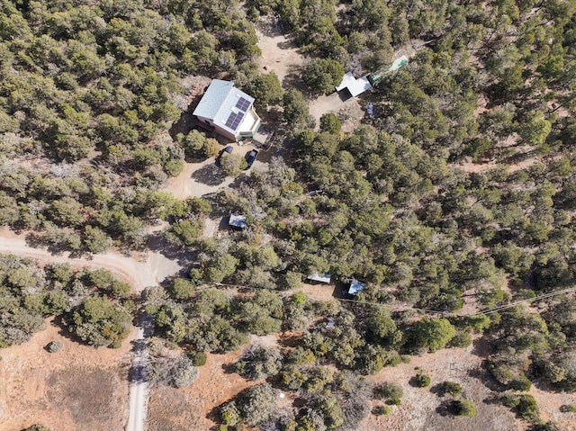 birds eye view of property with a view of trees