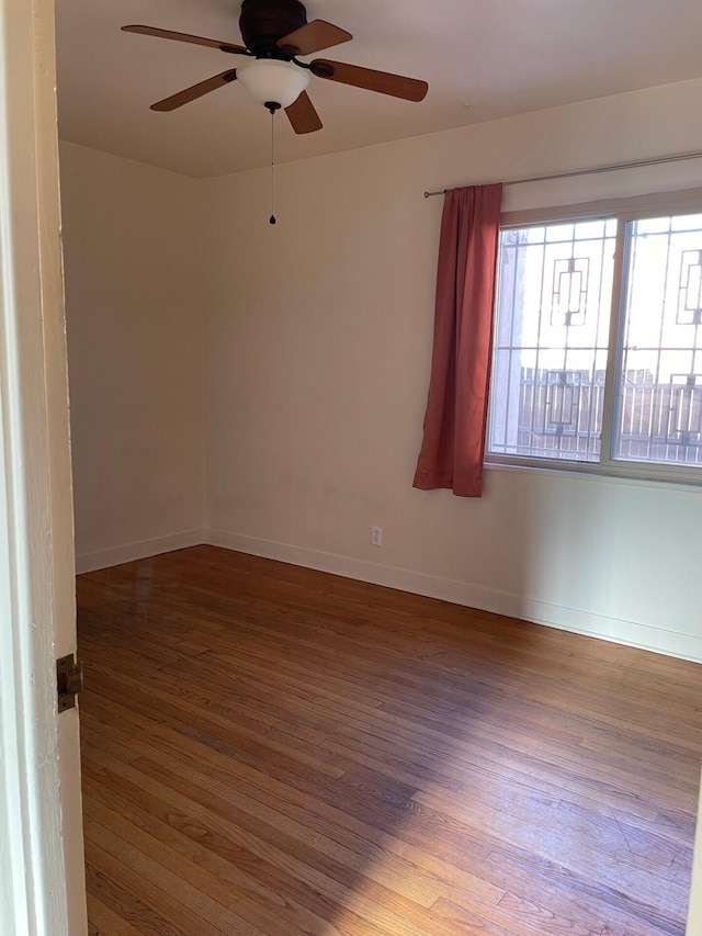 empty room featuring hardwood / wood-style flooring and ceiling fan