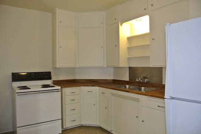 kitchen with white cabinetry, white appliances, and sink