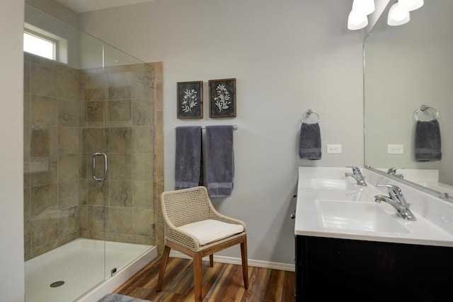 bathroom featuring wood-type flooring, an enclosed shower, and vanity