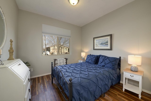 bedroom with dark hardwood / wood-style floors