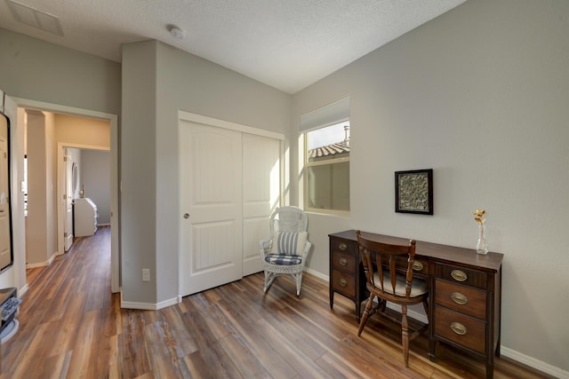 office space with dark hardwood / wood-style flooring and a textured ceiling