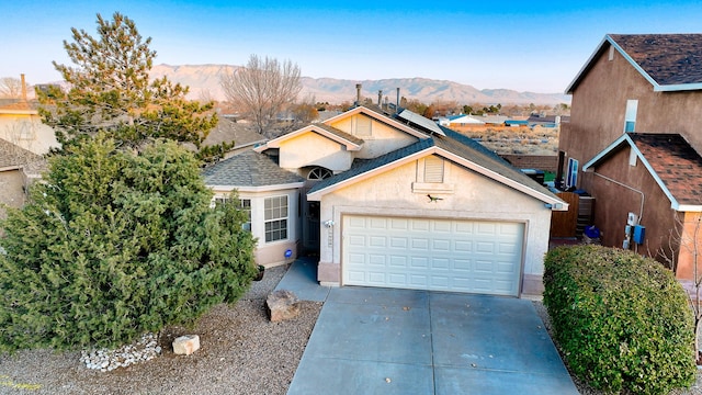 view of front of house featuring a mountain view and a garage