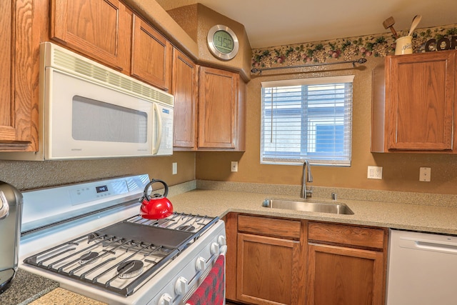 kitchen featuring sink and white appliances