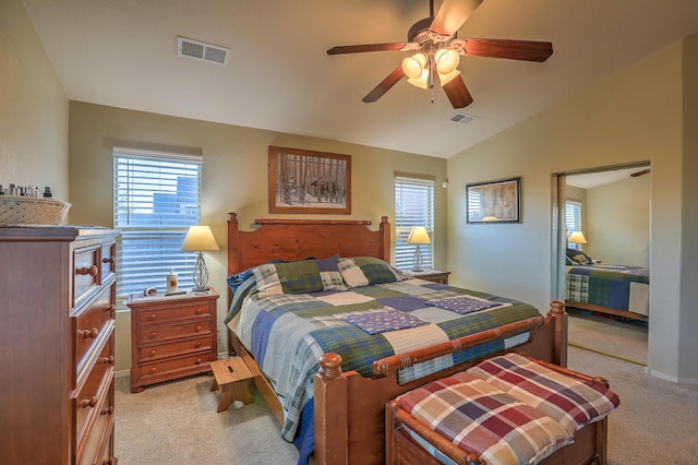 bedroom featuring multiple windows, lofted ceiling, light carpet, and ceiling fan