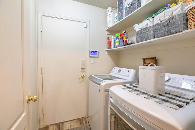 laundry area with hardwood / wood-style floors and washing machine and clothes dryer