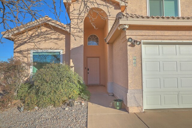 view of front of property with a mountain view, a garage, and central AC