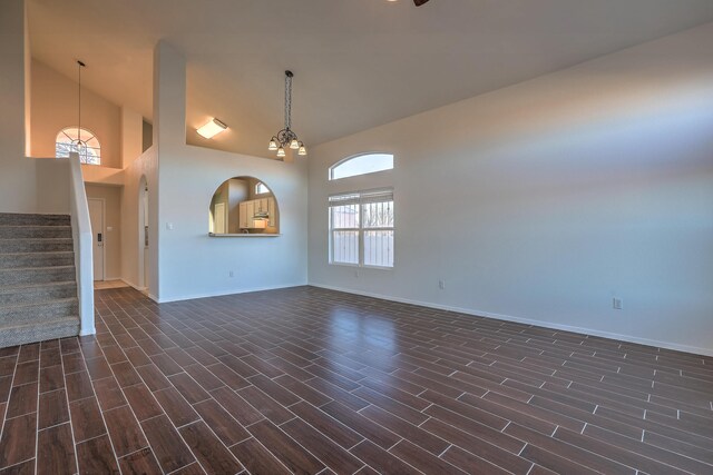 unfurnished living room with a chandelier and a high ceiling