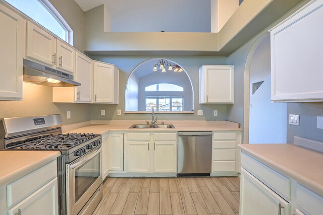 kitchen with white cabinetry, sink, a wealth of natural light, and appliances with stainless steel finishes