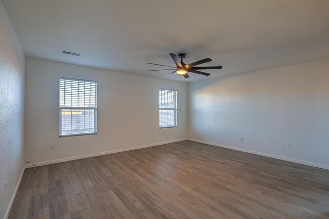 unfurnished room featuring dark hardwood / wood-style floors and ceiling fan