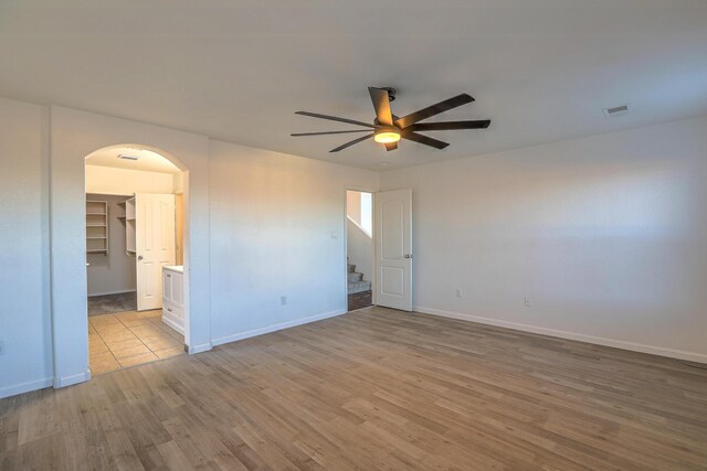 empty room featuring ceiling fan and light hardwood / wood-style floors