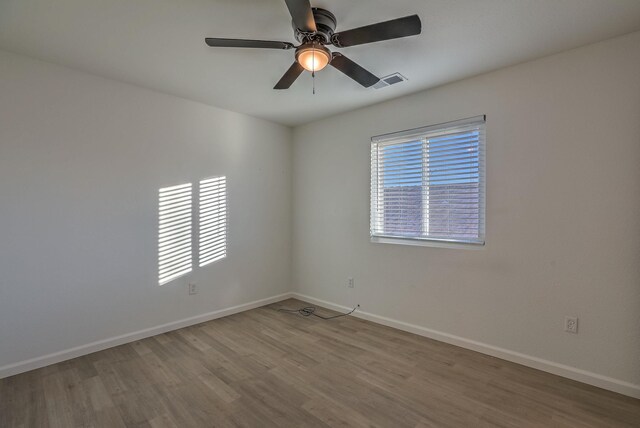 spare room featuring ceiling fan and light hardwood / wood-style flooring