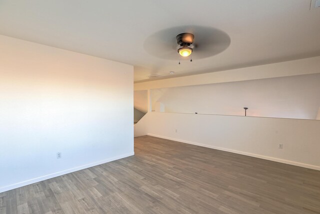 unfurnished room featuring dark hardwood / wood-style floors and ceiling fan