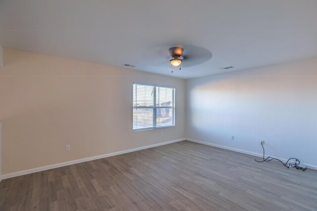 unfurnished room featuring ceiling fan and light wood-type flooring