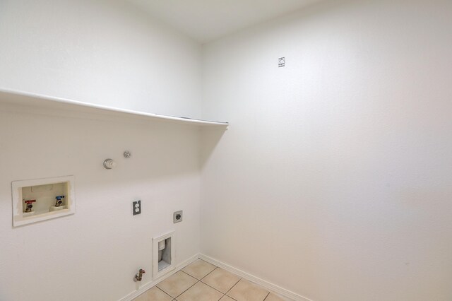 laundry area with gas dryer hookup, light tile patterned floors, hookup for a washing machine, and electric dryer hookup