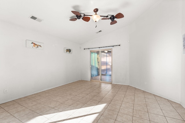 unfurnished room featuring lofted ceiling, ceiling fan, light tile patterned floors, and visible vents