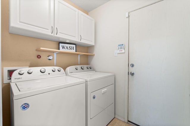 washroom featuring cabinets and washing machine and dryer