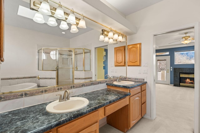 bathroom featuring a healthy amount of sunlight, a sink, and a shower stall