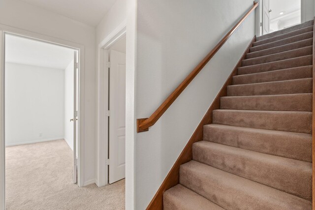 stairs featuring carpet floors and baseboards