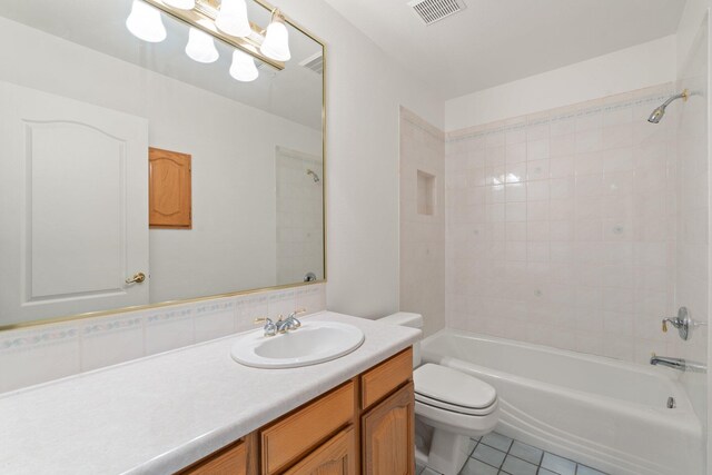 bathroom with visible vents, bathing tub / shower combination, toilet, tile patterned floors, and vanity