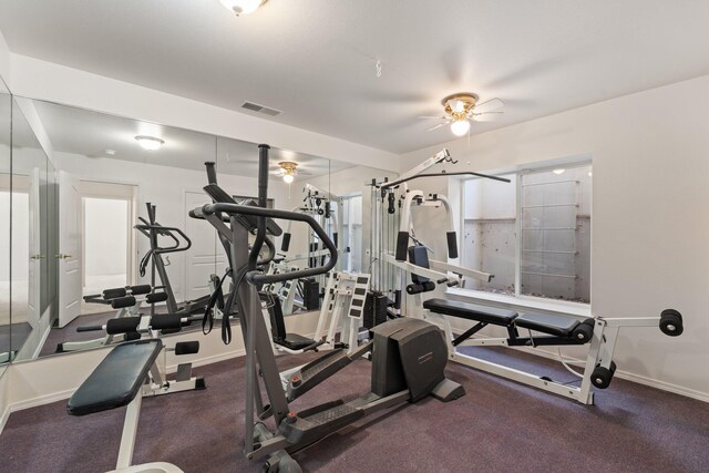 exercise area with baseboards, visible vents, and a ceiling fan