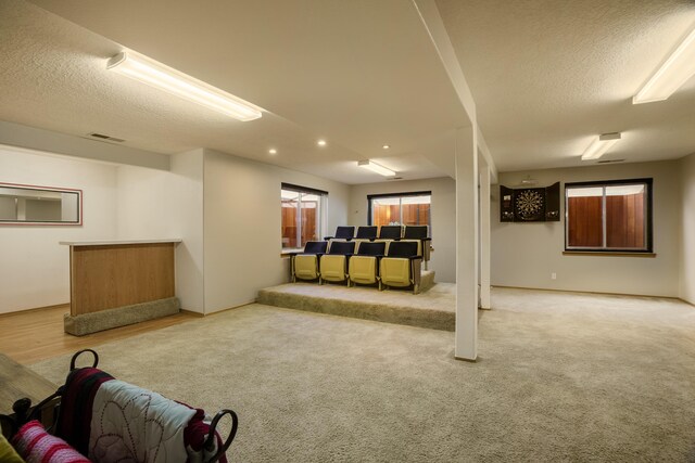 basement featuring carpet flooring and a textured ceiling