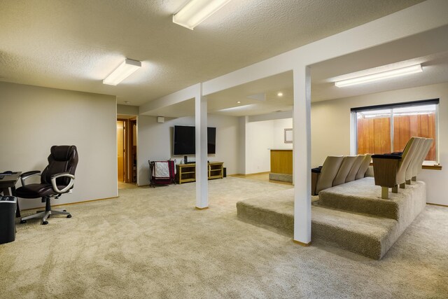 basement featuring a textured ceiling and carpet flooring