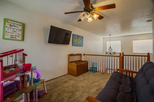 carpeted living room featuring ceiling fan with notable chandelier and a textured ceiling