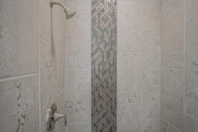 interior details with a tile shower