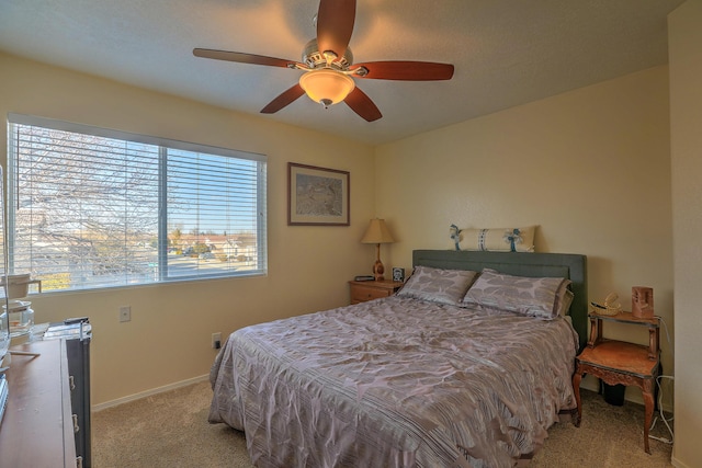 bedroom featuring light colored carpet and ceiling fan