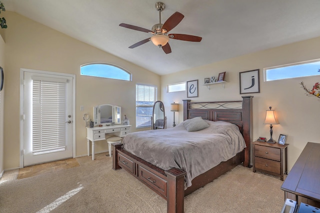 bedroom with ceiling fan, vaulted ceiling, and light carpet