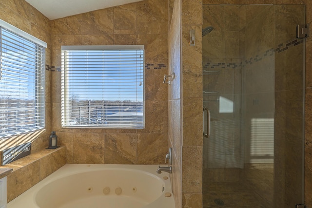 bathroom featuring lofted ceiling and plus walk in shower