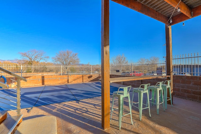 view of swimming pool featuring exterior bar and a patio area