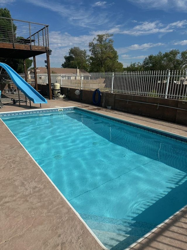 view of swimming pool with a water slide