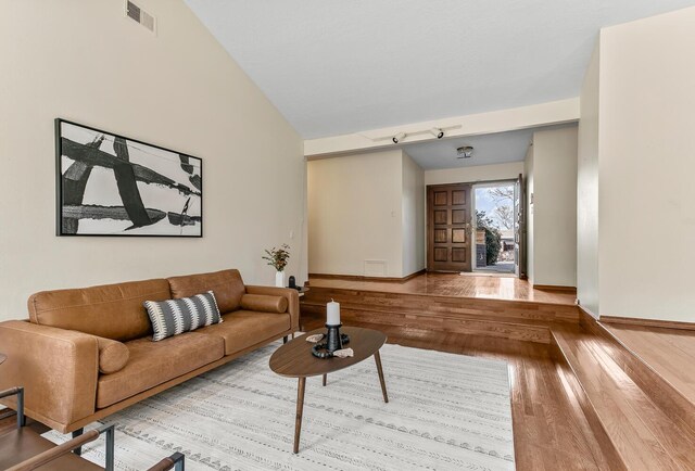 living room with a skylight, french doors, and light tile patterned flooring