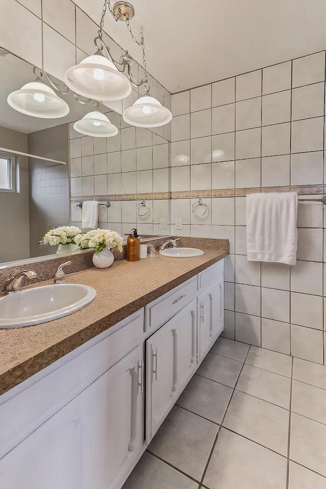 bathroom with tile patterned flooring, vanity, and tile walls