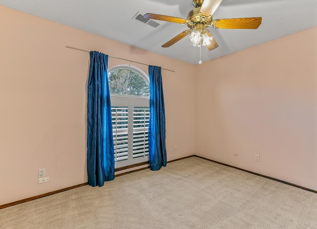 carpeted empty room with ceiling fan