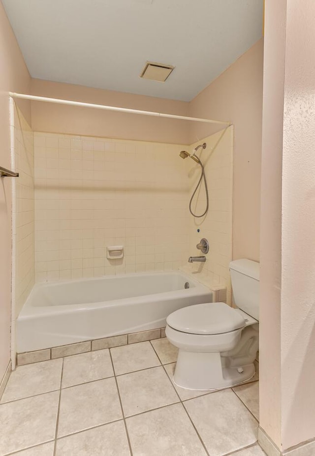full bathroom featuring tile patterned flooring, bathing tub / shower combination, and toilet