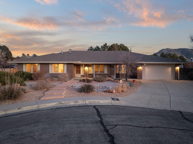 ranch-style house with a mountain view and a garage