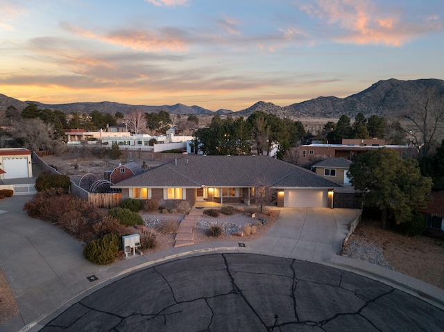 view of front of home with a garage and a mountain view