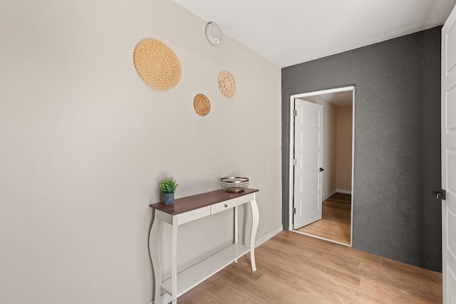 hallway with light hardwood / wood-style floors