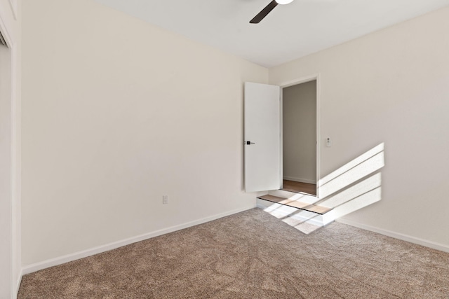 unfurnished room with ceiling fan and carpet flooring