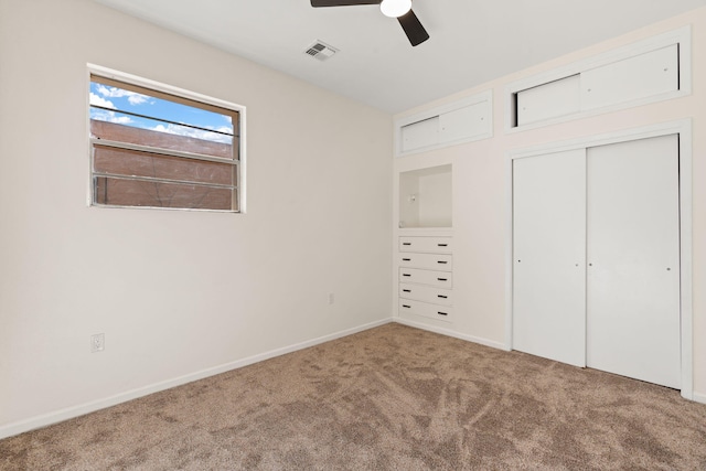 unfurnished bedroom featuring carpet floors, a closet, and ceiling fan