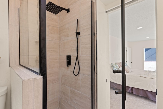 bathroom featuring toilet and tiled shower