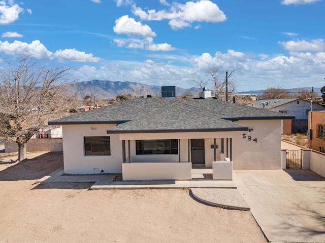 back of house with a mountain view and a patio area