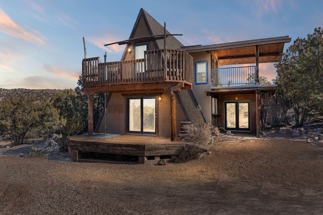 back house at dusk with a deck